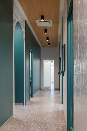 Modern interior hallway with teal accents connecting treatment rooms at our veterinary hospital in Kelowna